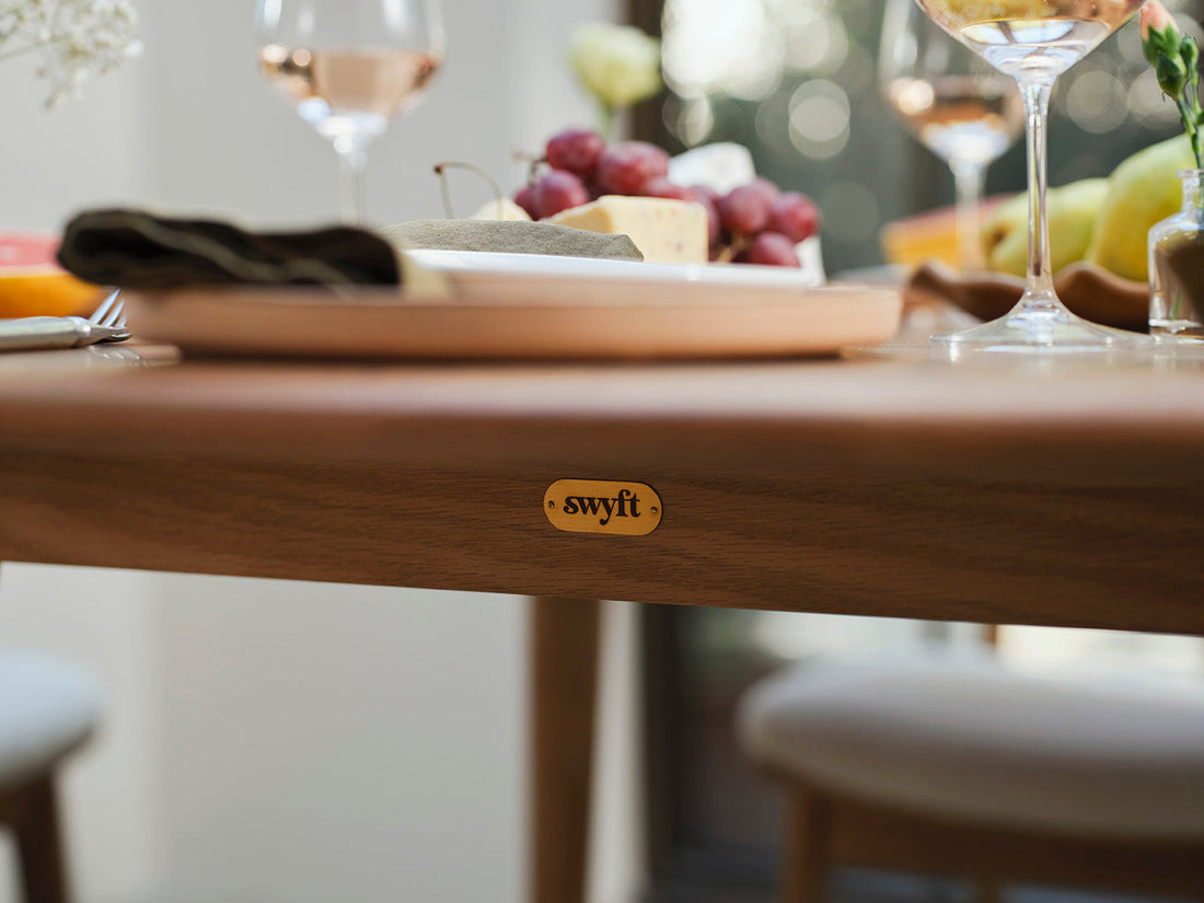Swyft metal logo tag on a dining table