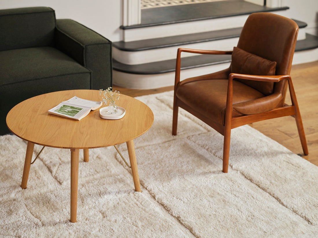 A tan occasional chair and a coffee table